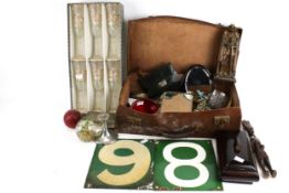 A group of assorted collectables in an old suitcase.