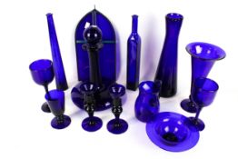 A collection of Bristol Blue cobalt glass items. Including a ships decanter, vase, etc. Max.