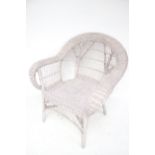 A wicker armchair. Painted grey.