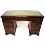 A reproduction mahogany Georgian style twin pedestal desk. With green inset leather top.