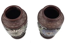 A pair of short Chinese bronze baluster vases. Both with champleve flower decoration, H11.