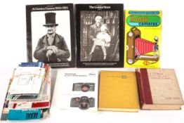 An assortment of photography books and camera manuals.