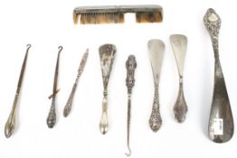 Four silver handled shoe horns, three button hooks, a nail file and a comb.