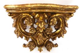 A contemporary carved wood gilt wall bracket. Decorated with flowers.