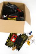 An assortment of Scalextric track and accessories. Including controllers, lapcounters, etc.