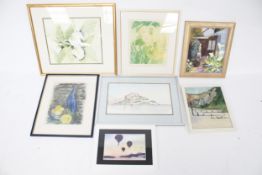 A collection of seven framed pictures.