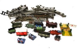 An assortment of O gauge model railway locomotive, rolling stock and track.