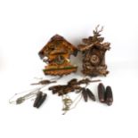 Two cuckoo clocks. Both made in Germany, with Alpine theme cases, with pine come weights, pendulums.