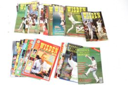 A collection of vintage Wisden Cricket magazines.