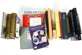 An assortment of books relating to art and watches.