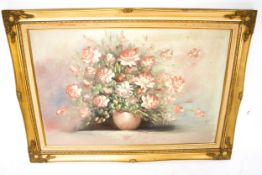 A still life painting of a bowl of roses, signed 'Jone'. In a guilt wood frame.
