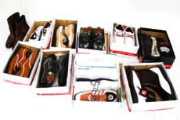 Nine pairs of boxed golf shoes.