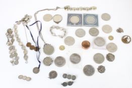 A collection of coins, medallions and coin jewellery including a sixpence eight-coin bracelet.