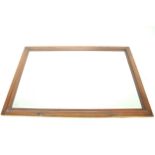 A wooden framed bevel edged wall mirror.
