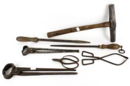 A collection of assorted Blacksmith's tools and hammer. Including tongs and a file, etc.