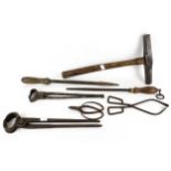 A collection of assorted Blacksmith's tools and hammer. Including tongs and a file, etc.