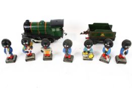 Seven Robertson hand painted pottery band figures and a tin plate train. Max.