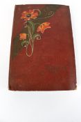 An early 20th century postcard and silk embroidered card album.