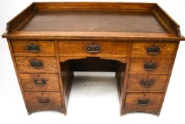 A late Victorian/early Edwardian twin pedestal oak desk. With an inset top and gallery rail.