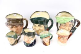 Seven Royal Doulton character jugs. One modelled as an elderly woman, a winking devious man, etc.