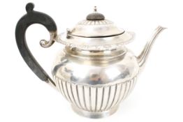 An early-mid 20th century silver round teapot on foot.