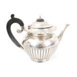 An early-mid 20th century silver round teapot on foot.