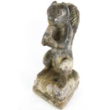 A late 18th century lead covered garden art stone sculpture of a squirrel eating an acorn.