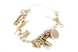 A vintage 9ct gold curb link 'charm' bracelet, hung with circa ten charms.