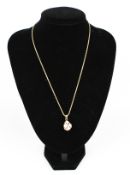 A modern 9ct gold fancy rope link necklace hung with a gold-plated,