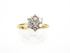 An 18ct gold and diamond cluster ring. The seven round brilliants approx. 0.