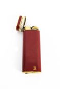 Must de Cartier, a gold-plated and red lacquer oblong pocket lighter ref G 18106.