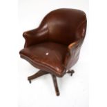 A circa. 1900 brown leather adjustable office tub chair.