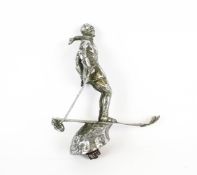 A chrome plated car mascot in the form of a Riley skier.
