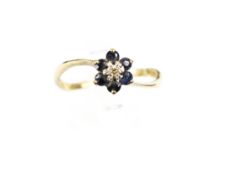A 9ct gold sapphire and tiny diamond cluster ring. Hallmarks for London 1980, size N+, 1.