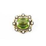 A late Victorian gold, peridot and half-pearl oblong brooch.