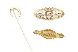 Two late Victorian/early 20th century gold brooches and a stick pin.