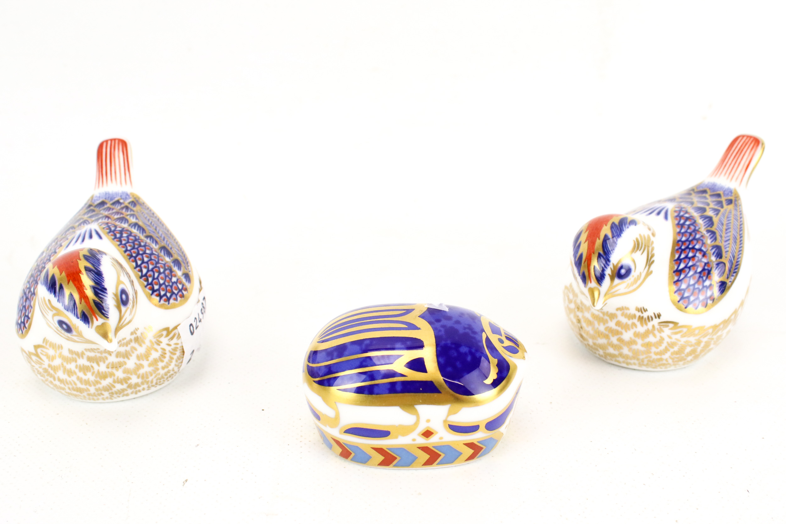 Three Royal Crown Derby paperweights.