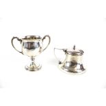 A silver miniature trophy cup and a mustard pot.