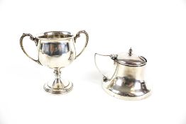 A silver miniature trophy cup and a mustard pot.