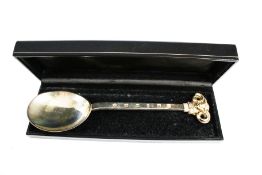 A modern silver spoon with a rams mask terminal.