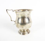 A silver baluster-shaped christening mug.