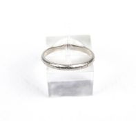 A vintage platinum wedding band. D-section and formerly engraved, stamped 'PLAT', 2.