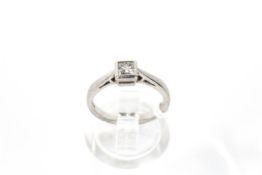 A modern platinum and diamond solitaire ring. The princess-cut diamond approx. 0.