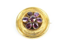 A Victorian gold and garnet seven-stone round brooch.