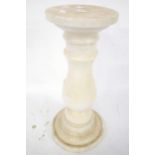 A three piece turned white marble column stand. With detachable top.