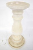 A three piece turned white marble column stand. With detachable top.