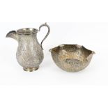 An Indian white metal baluster shaped milk jug and a shaped round sugar(?) bowl.