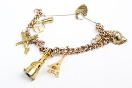 An early 20th century rose gold curb link 'charm' bracelet.