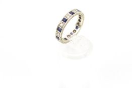 A 9ct white gold, sapphire and diamond eternity ring.