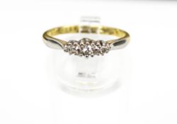 A vintage gold and small diamond three stone illusion ring.